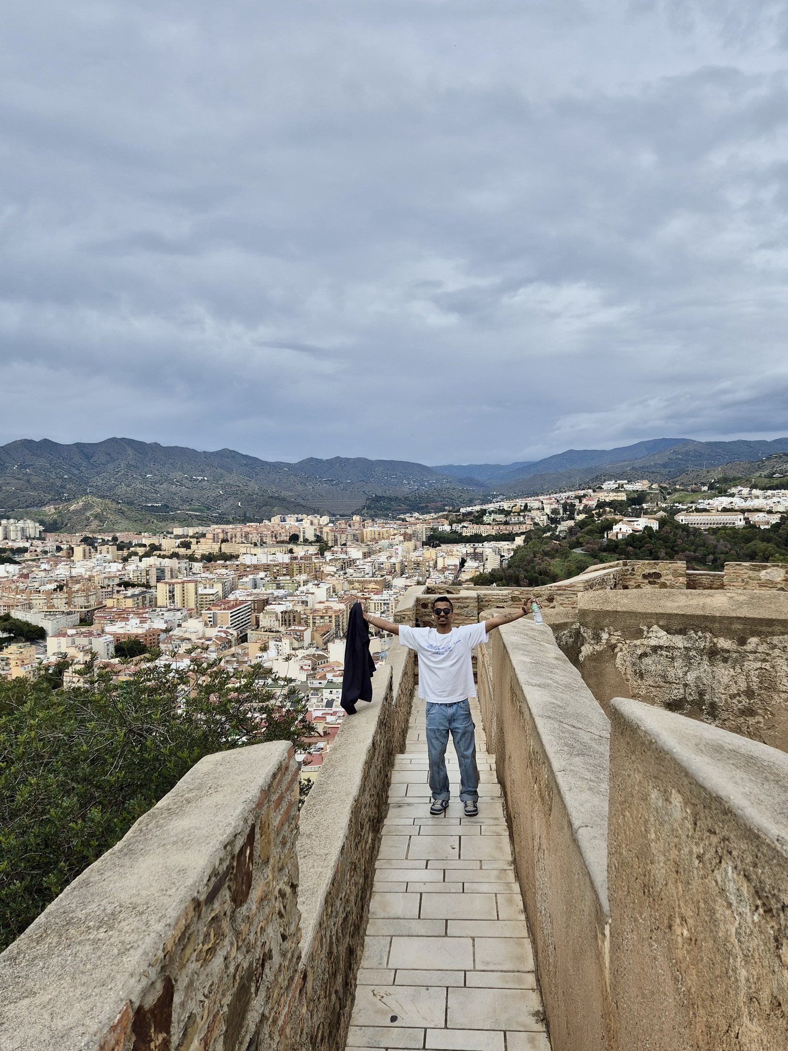 Arms spread on a castle walkway