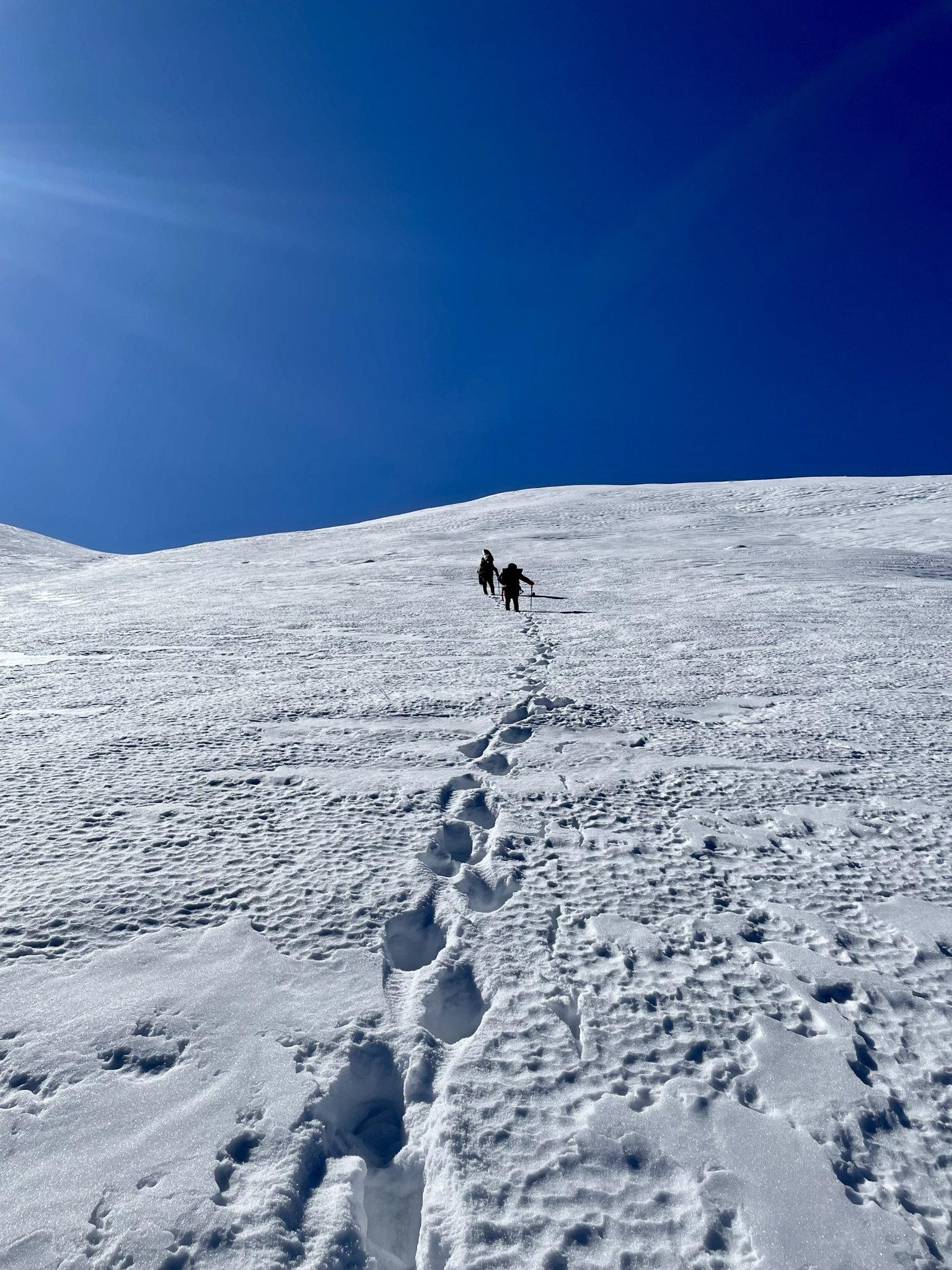 Hiking up a snowy slope in the Himalayas